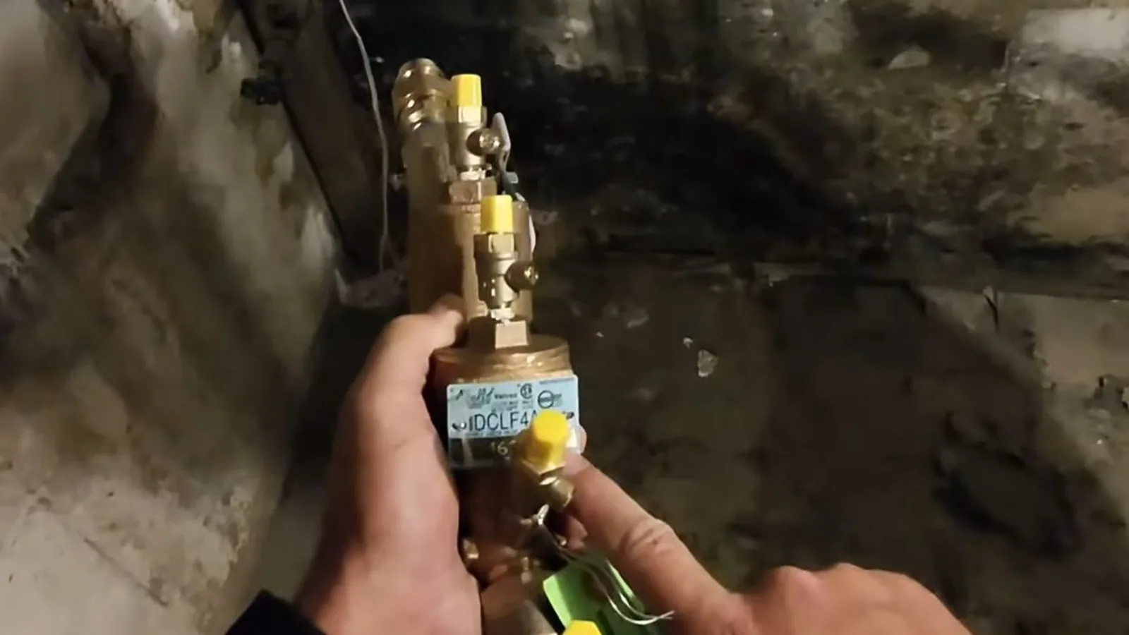 A backflow preventer valve body being inspected for wear, illustrating Fulton County Backflow Testing: What Alpharetta Homeowners Must Do Each Year