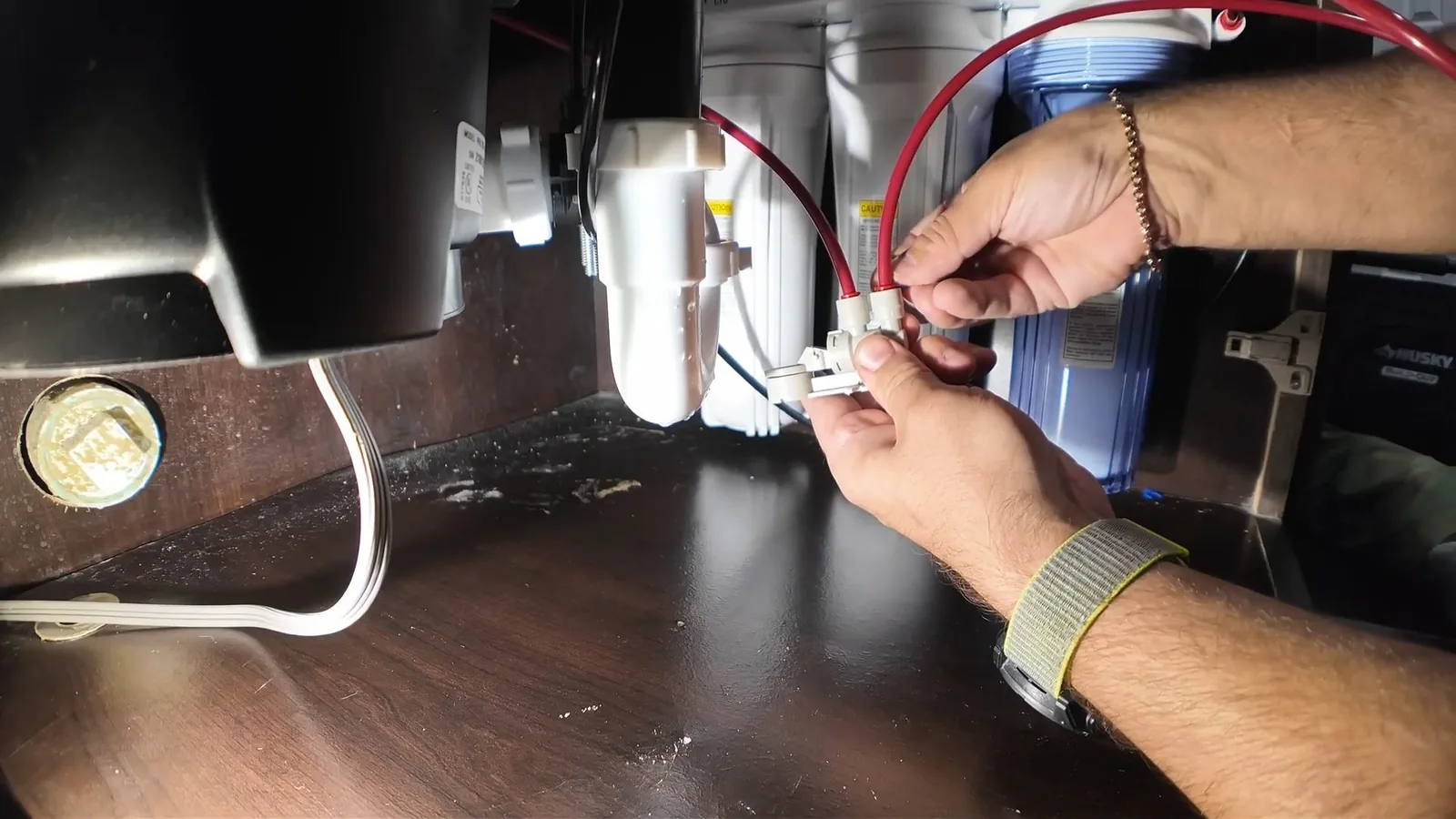A jammed disposal being cleared with an Allen wrench during Garbage Disposal Repair & Installation service in Alpharetta