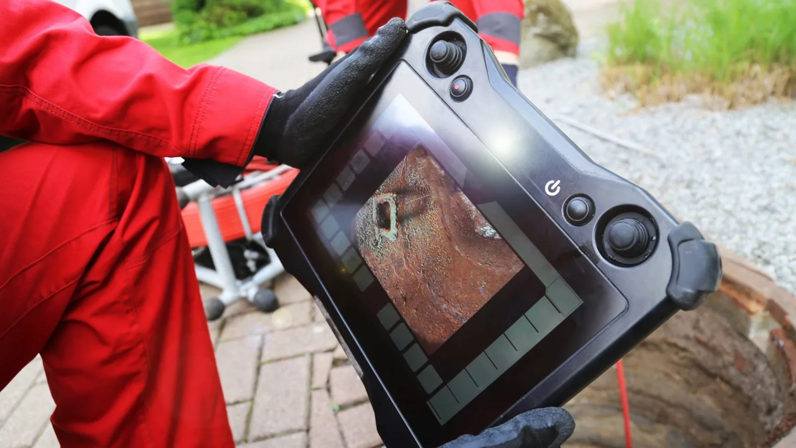 A technician monitoring a trenchless repair from the access point, related to Tree Roots in Your Alpharetta Sewer Line? Signs, Cost, and When to Trench